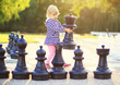 © Zsolt Biczó - Child with huge chess figures outdoor