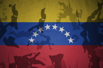 flag of venezuela on the khaki texture . military concept