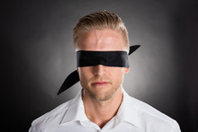 Businessman With A Black Blindfold Over Eyes