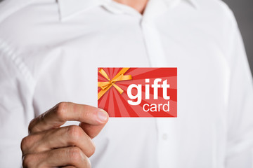 Wall Mural - Man Holding Gift Card