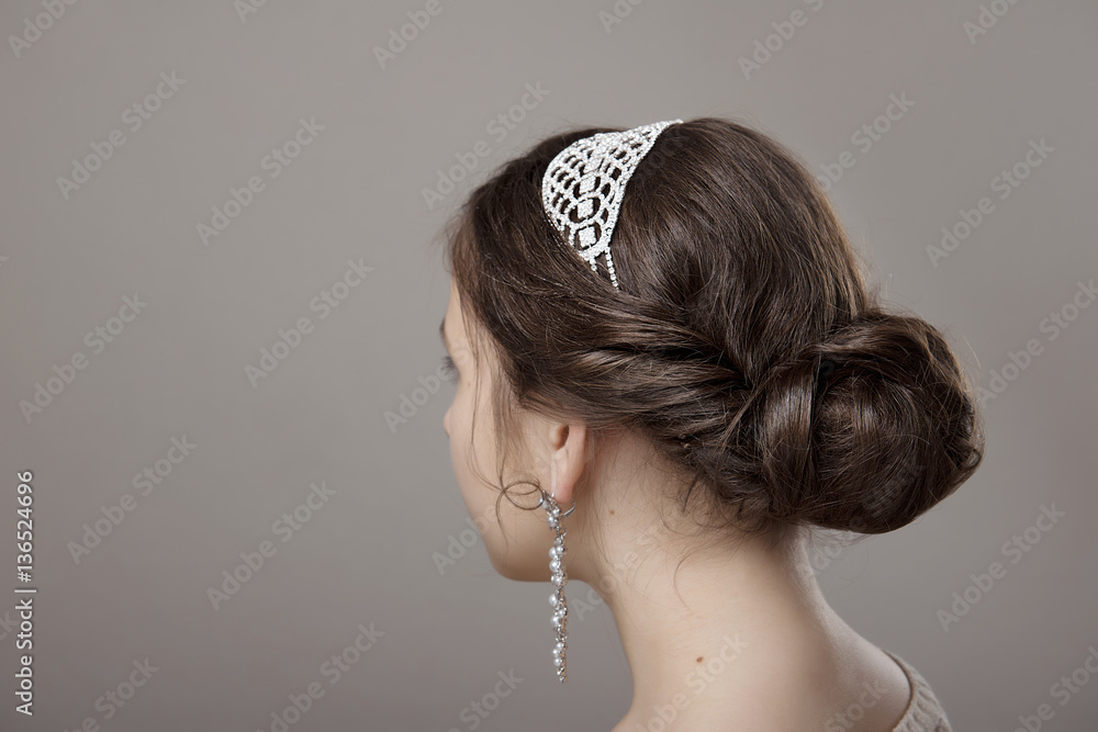 head of woman with hair in bun on gray isolated background - obrazy, fototapety, plakaty 