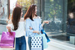 two young happy asian women shopping outdoor shopping mall in a