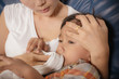 © sutadimages - mother and sick boy,sitting on sofa
