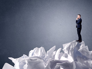 Businessman standing on crumpled paper