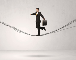 Sales person balancing on drawn ropes