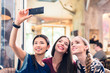 © Kzenon - Three young women making selfie photos in a restaurant