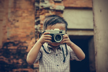 Little Boy With A Vintage Camera