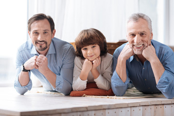 Positive happy family looking at you