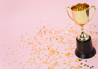 Wall Mural - gold winner cup on pink background