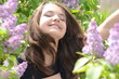 © Лариса Мотуз - Girl laughing inhaling the scent of lilac