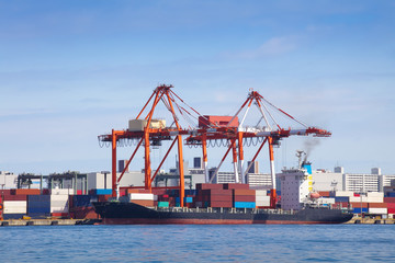 Cargo freight ship with stacked container at harbor terminal