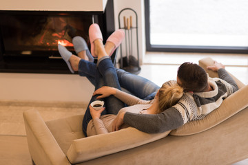 Young couple  in front of fireplace