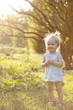 © Сергей Лабутин - Cute cheerful little girl in a summer park at sunset
