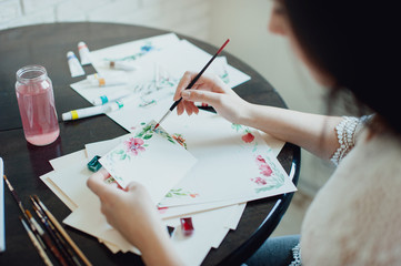 The girl in a beautiful white dress watercolor paints. Artist