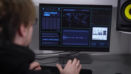 Back view of professinal hacker making cyber attack on network of the Bank. Spy is typing fast on keyboard trying to match password. Message about granted access is appeared on the screen.