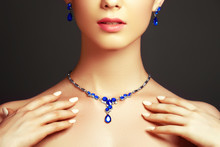 Elegant Fashionable Woman With Jewelry. Beautiful Woman With A Sapphire Necklace. Beauty Young Model With A Diamond Pendant On A Gray Background. Jewellery And Accessories. Beauty And Fashion Concept