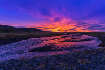 Sunrise over the wild river. Landscape in Iceland, colored sky s