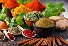 Variety Of Spices And Herbs On Kitchen Table