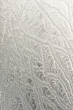 Fototapeta Sypialnia - A beautiful pattern created by frost on glass