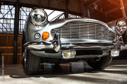 closeup of the headlights and front bumper Poster