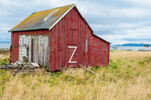 Red Wooden Old Barn With Big White Z On The Door In The Countryside