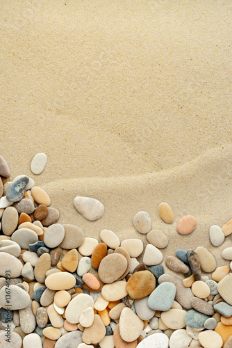 Fototapeta na wymiar Sand background with pebbles. Sandy beach texture