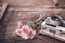 Vintage Camera With Bouquet Of Flowers On Old Wood Background - Concept Of Nostalgic And Remembrance In Spring Vintage Background