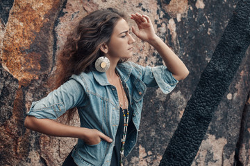 Wall Mural - atrractive young woman in denim coat outdoors