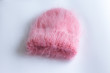 © sedan504 - Much fluffy and warm hat pink knitted by hand on a white background