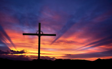 Wall Mural - Cross silhouette on the mountain at sunset