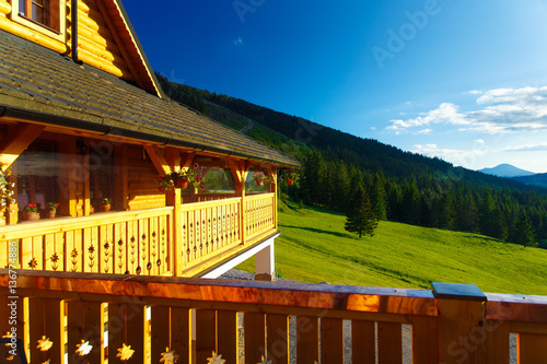 Rural Cottage In The Mountains And Green Meadow Sunset Scenery