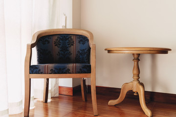 Vintage chair and table at window in the room.