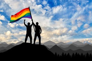 Wall Mural - Silhouette of a gay couple with rainbow flag at the top