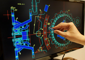 engineer working on mechanichal piece computer design