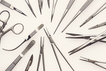 Flat View On Assorted Surgical Instruments On A White Background