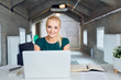 © baranq - Happy businesswoman working on laptop in modern office, start up, new business concept