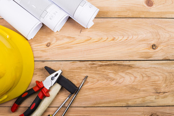 Safety equipment and tool kit on wooden background with copy space.