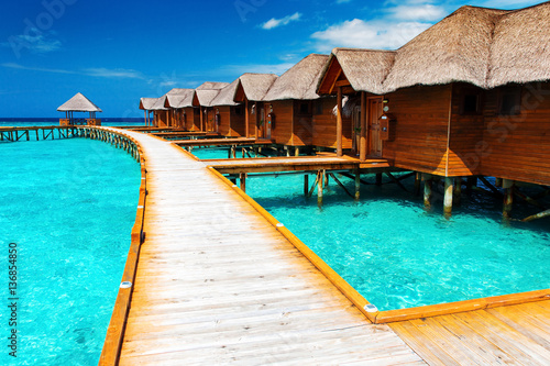 Water bungalows resort at islands. Indian Ocean, Maldives Poster