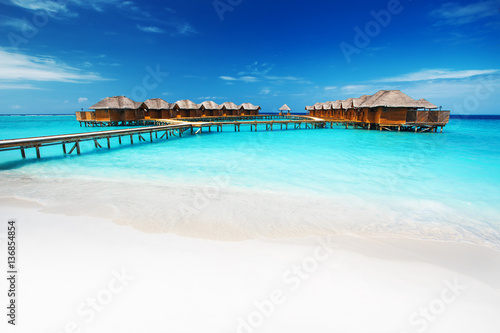 Water bungalows resort at islands. Indian Ocean, Maldives Poster