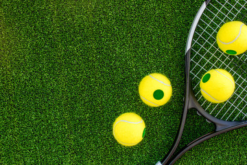 Wall Mural - tennis racket on green background top view