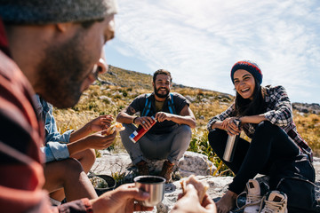 Wall Mural - group of people relaxing and eating during hike