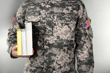 Poster - Soldier holding books. Military education concept