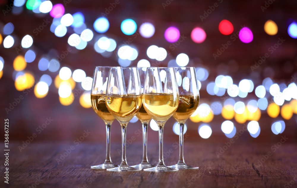 Glasses of wine in a row on bokeh background