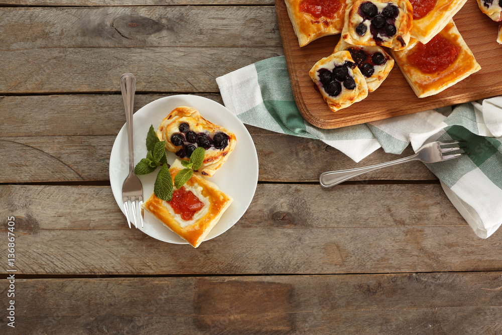 Sweet tasty pastries on wooden background, top view