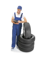 Wall Mural - Young mechanic in uniform with a clipboard, isolated on white