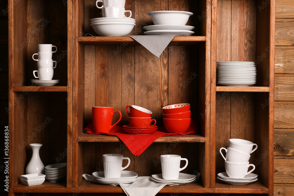 Wooden shelves with white and red rustic dinnerware