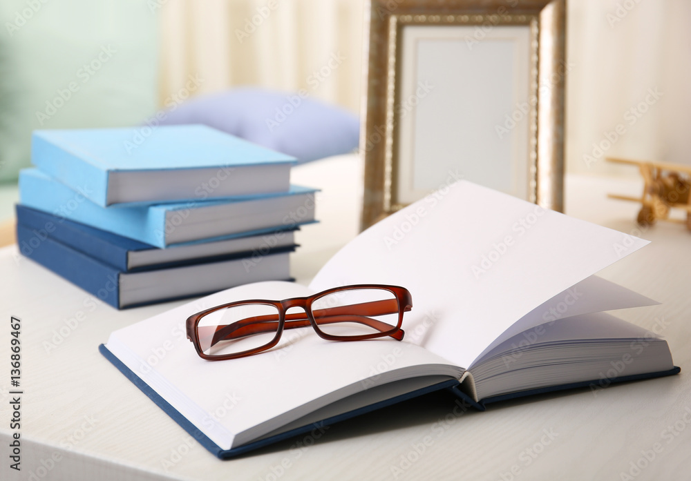 Open book on white wooden table