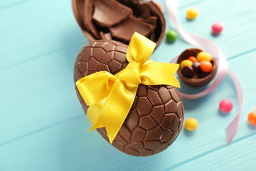 Sticker - Chocolate Easter eggs on color wooden background