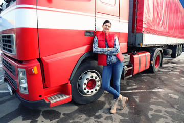 Young female driver near big modern truck outdoors