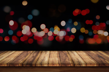 Wall Mural - wooden floor and city light with bokeh night background.